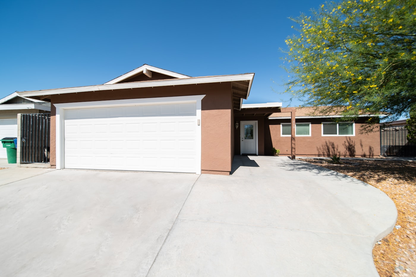 A freshly pressure-washed home and driveway
